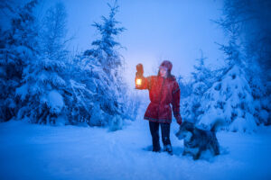 a women in the woods at night with a wolf by Aurora Acres (@theauroraacres)