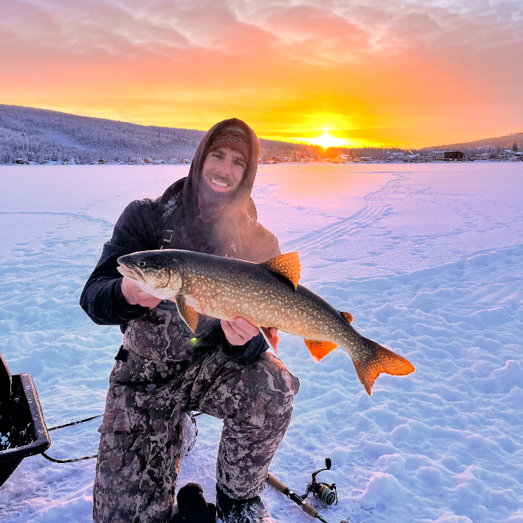 Oliver Anacan - @olleyeh holding a lake trout while fishing