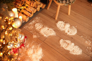 Footprints of Santa on floor in room decorated for Christmas