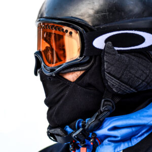 the side of a skiers face with goggles on