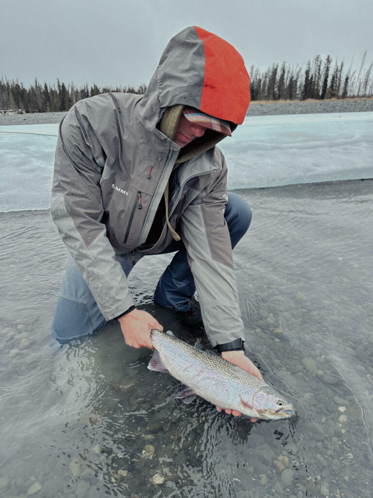 Oliver Anacan - @olleyeh holding a fish that he caught while fly fishing