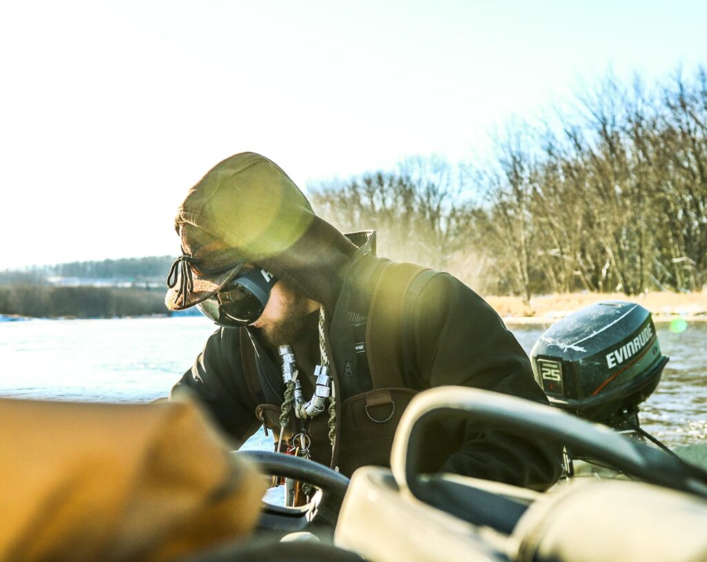 Dakota driving his boat in a stormy kromer hat