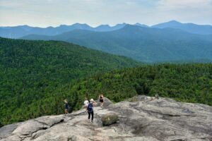 modle27 poses on top of the Adirondack mountain range