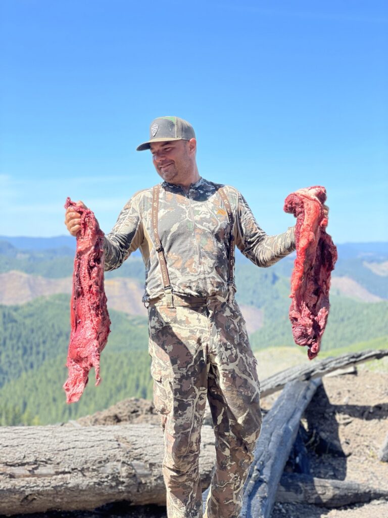 Justin Townsend poses with two wild game kills