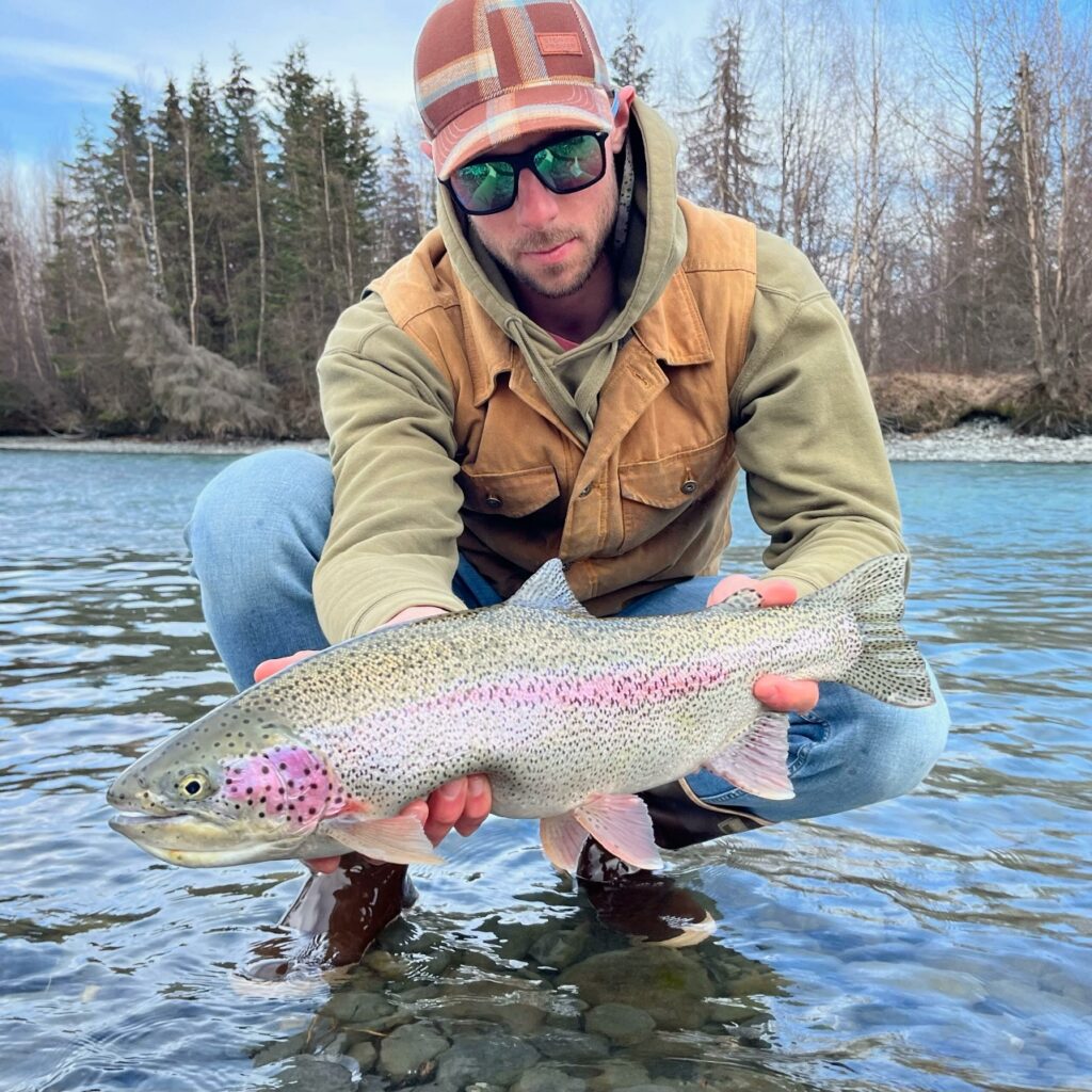 Oliver Anacan holds up a beautiful rainbow trout.