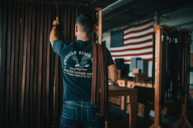 A member of the American Bench Craft team poses by a United States Flag