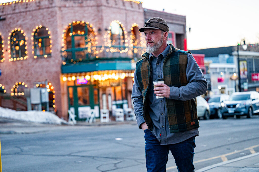 A man wears the Ironwood Vest - Isle Royale Collection from Stormy Kromer and American Woolen